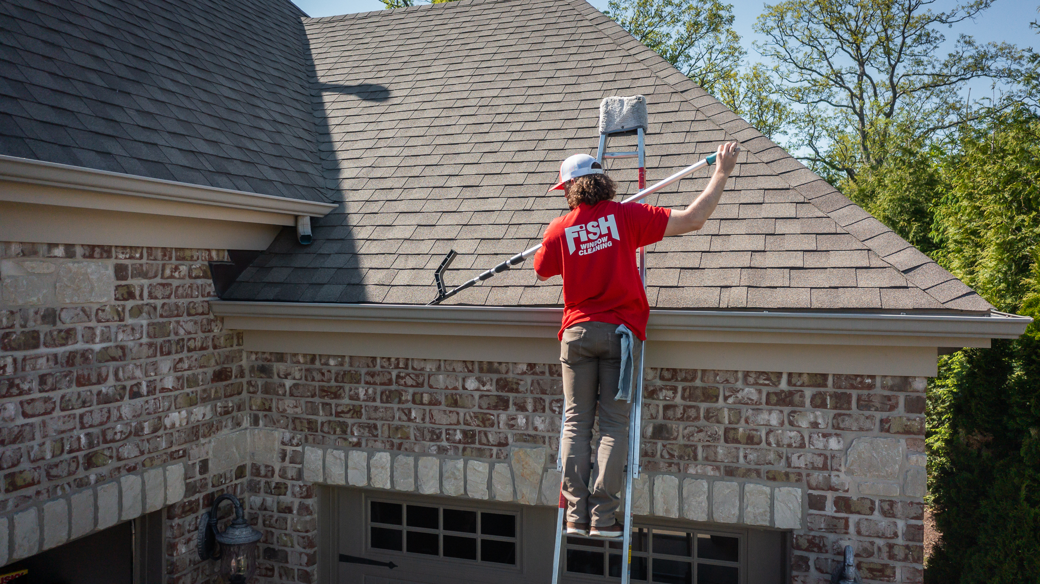 FISH Window Cleaner Using Tool to Clean Gutters on Ladder